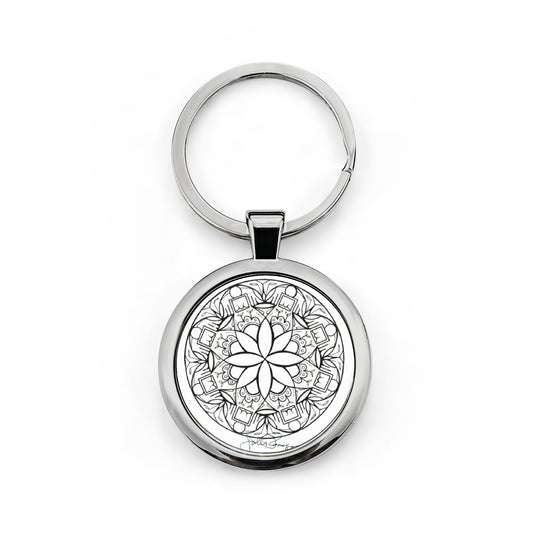 Silver keychain with a black and white mandala design on a white background